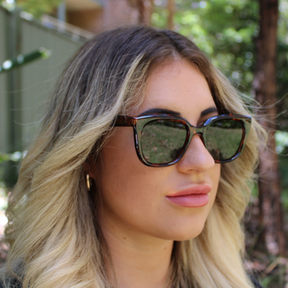 woman wearing abby tortoiseshell forest green sunglasses