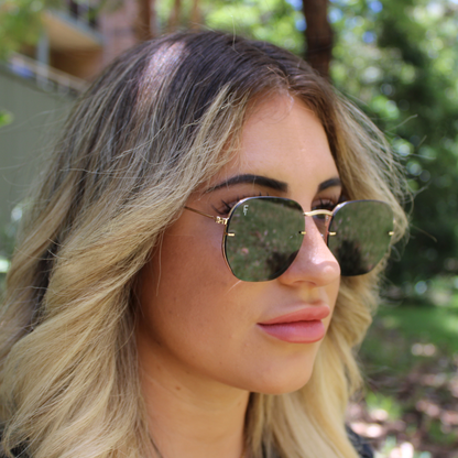 woman wearing brydan gold black sunglasses