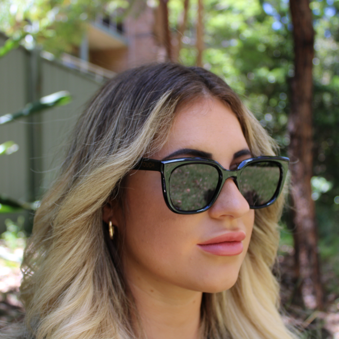 woman wearing Camila black sunglasses