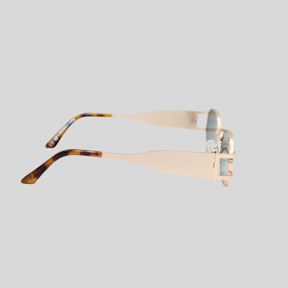 Charlotte gold forest green side with a gold frame and tortoiseshell arms on a light grey background