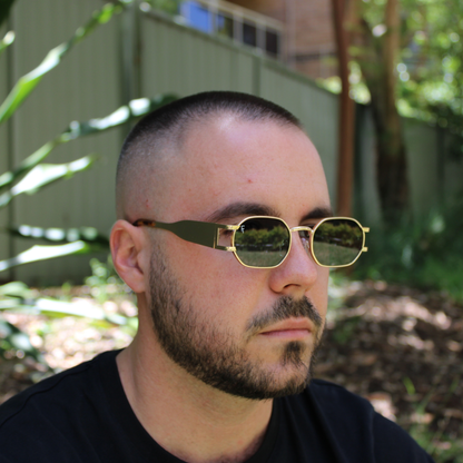 man wearing gold forest green sunglasses
