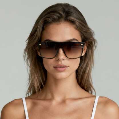 Female model wearing oversized sunglasses with black frame and amber lenses UV400 – Archie by Final Touch