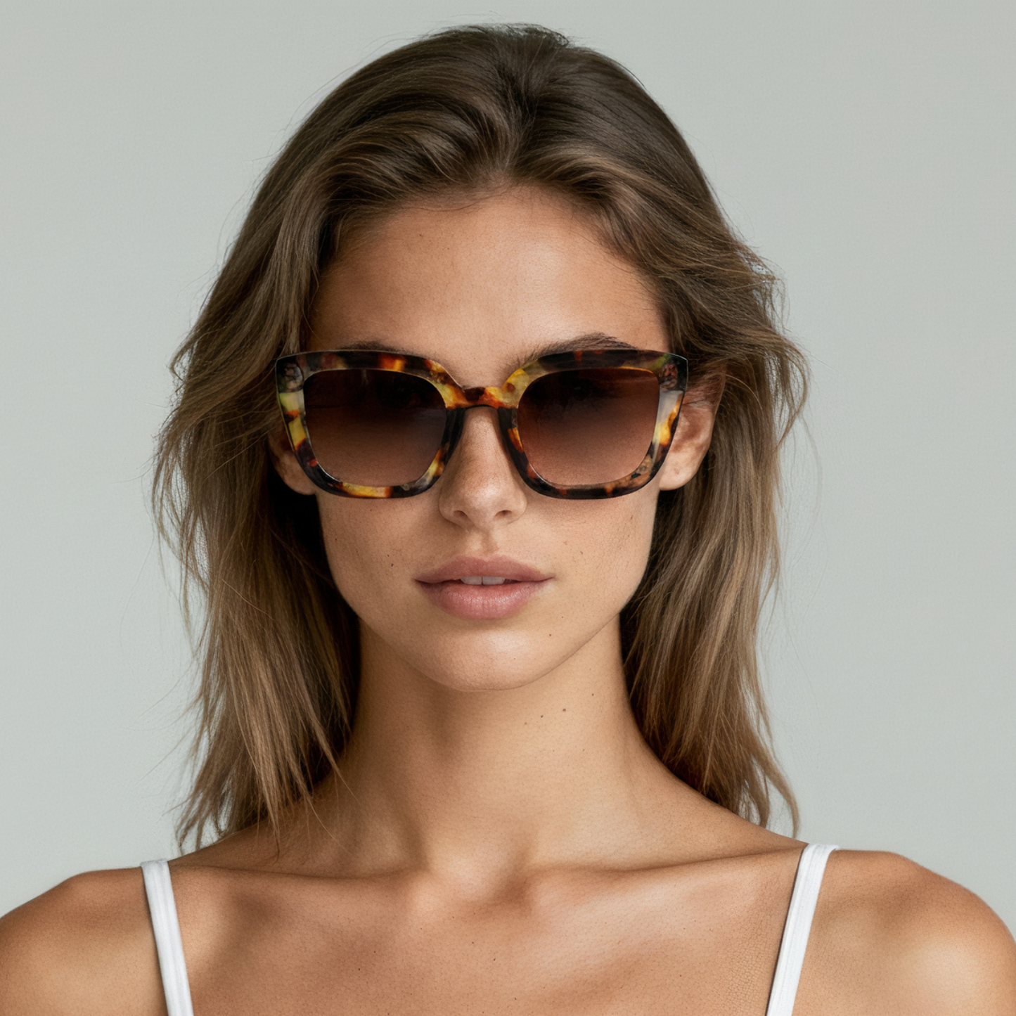 Female model wearing cat eye sunglasses with amber tortoise frame and brown lenses UV400 – Camila by Final Touch