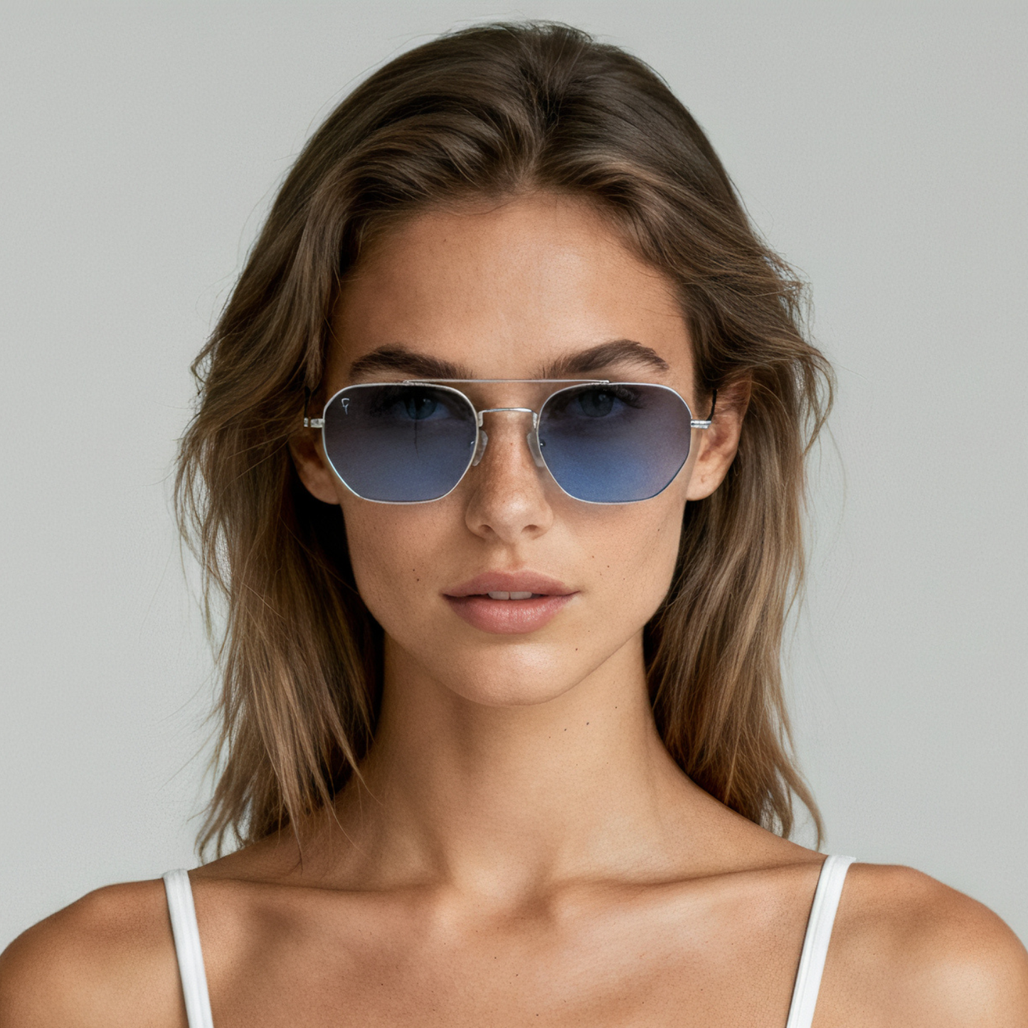 Female model wearing aviator sunglasses with silver frame and blue lenses UV400 – Lennon by Final Touch