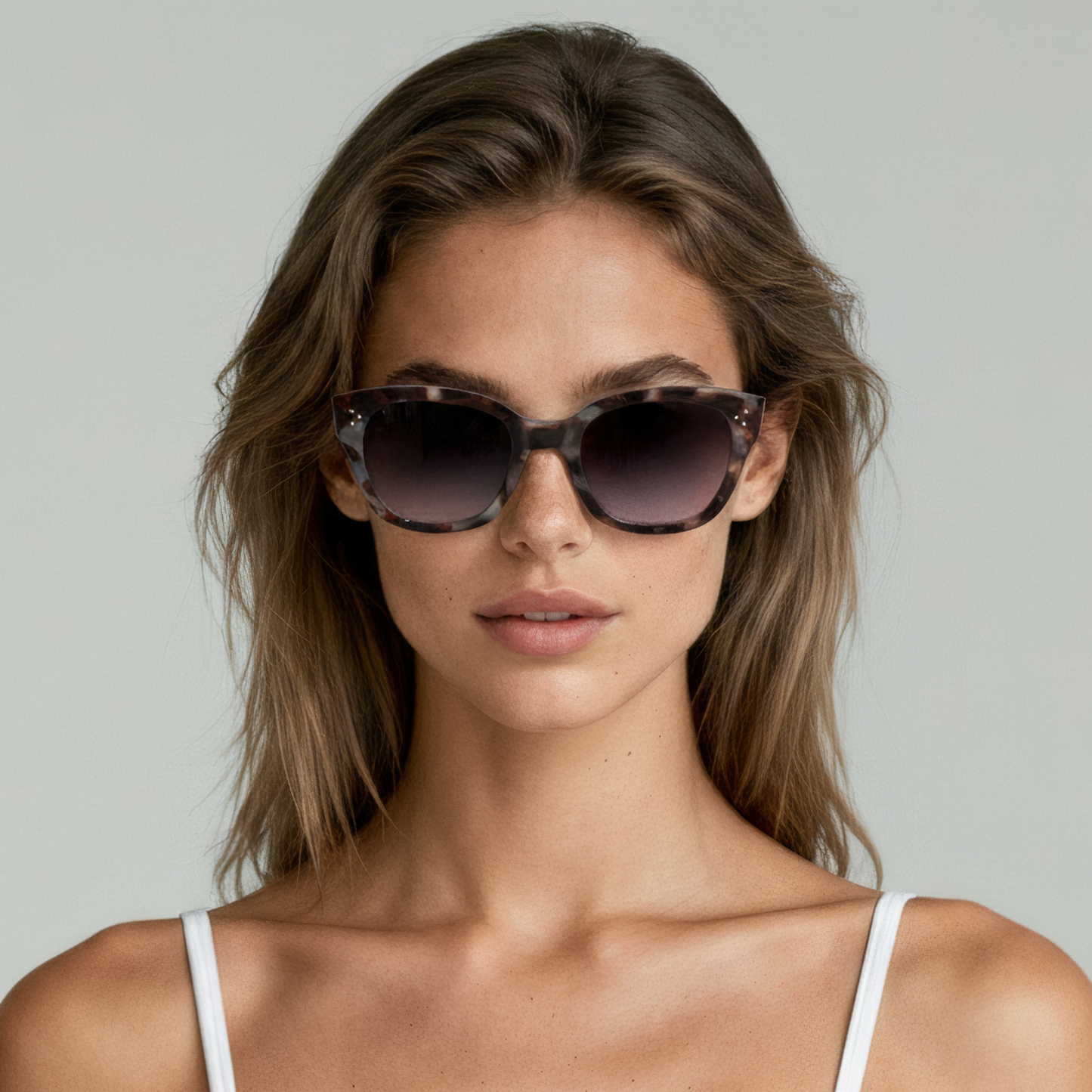 Female model wearing cat eye sunglasses with dark tortoiseshell frame and brown lenses UV400 – Nicky by Final Touch