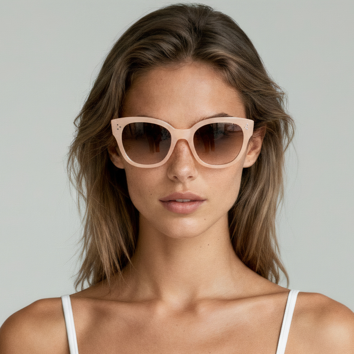 Female model wearing cat eye sunglasses with nude frame and smoke lenses UV400 – Nicky by Final Touch