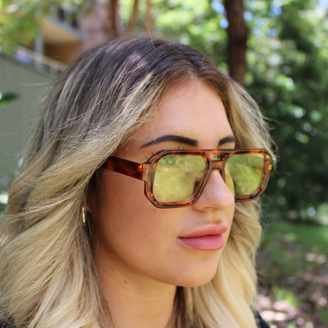 woman wearing jensen tortoiseshell green sunglasses 